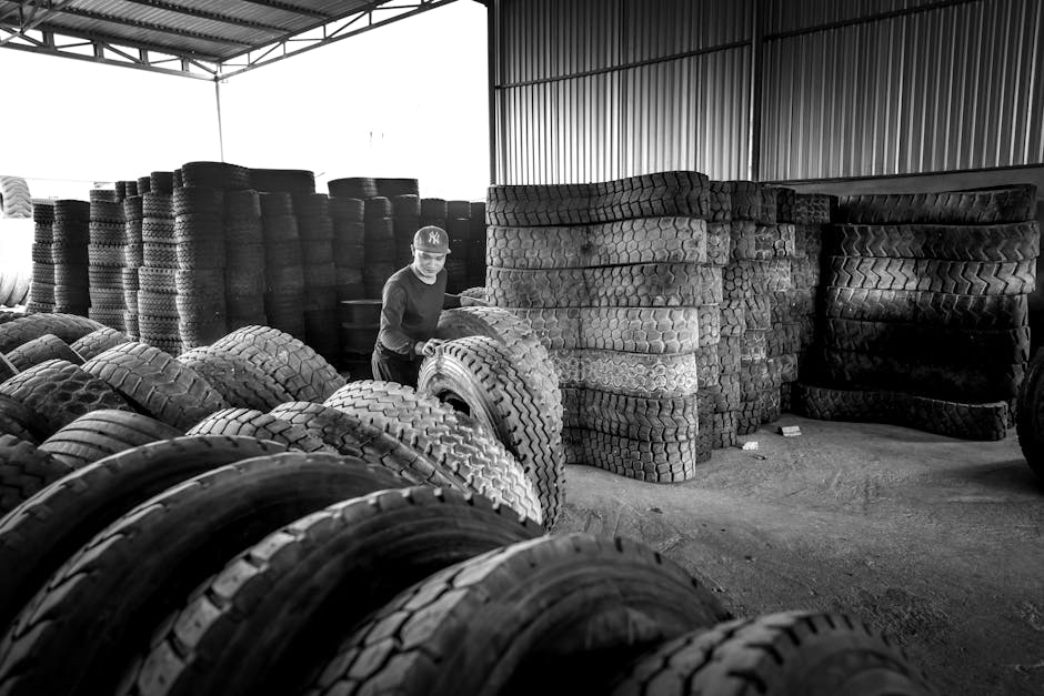 Car tires stacked neatly in a professional warehouse facility